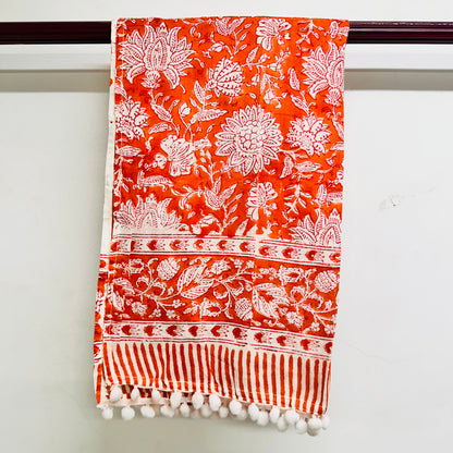 Orange scarf with white floral and striped patterns