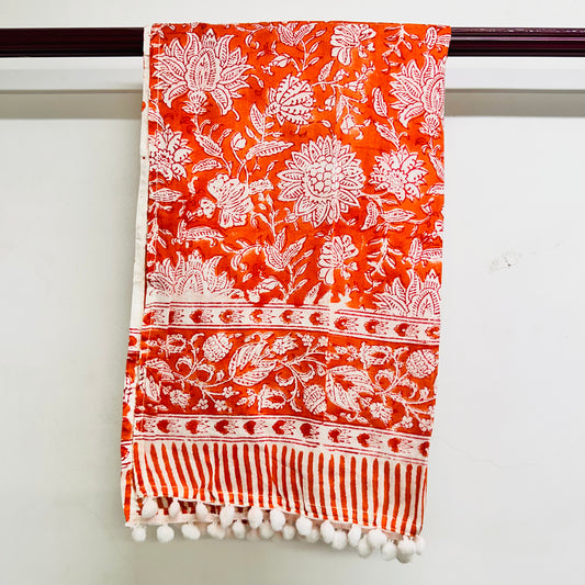 Orange scarf with white floral and striped patterns