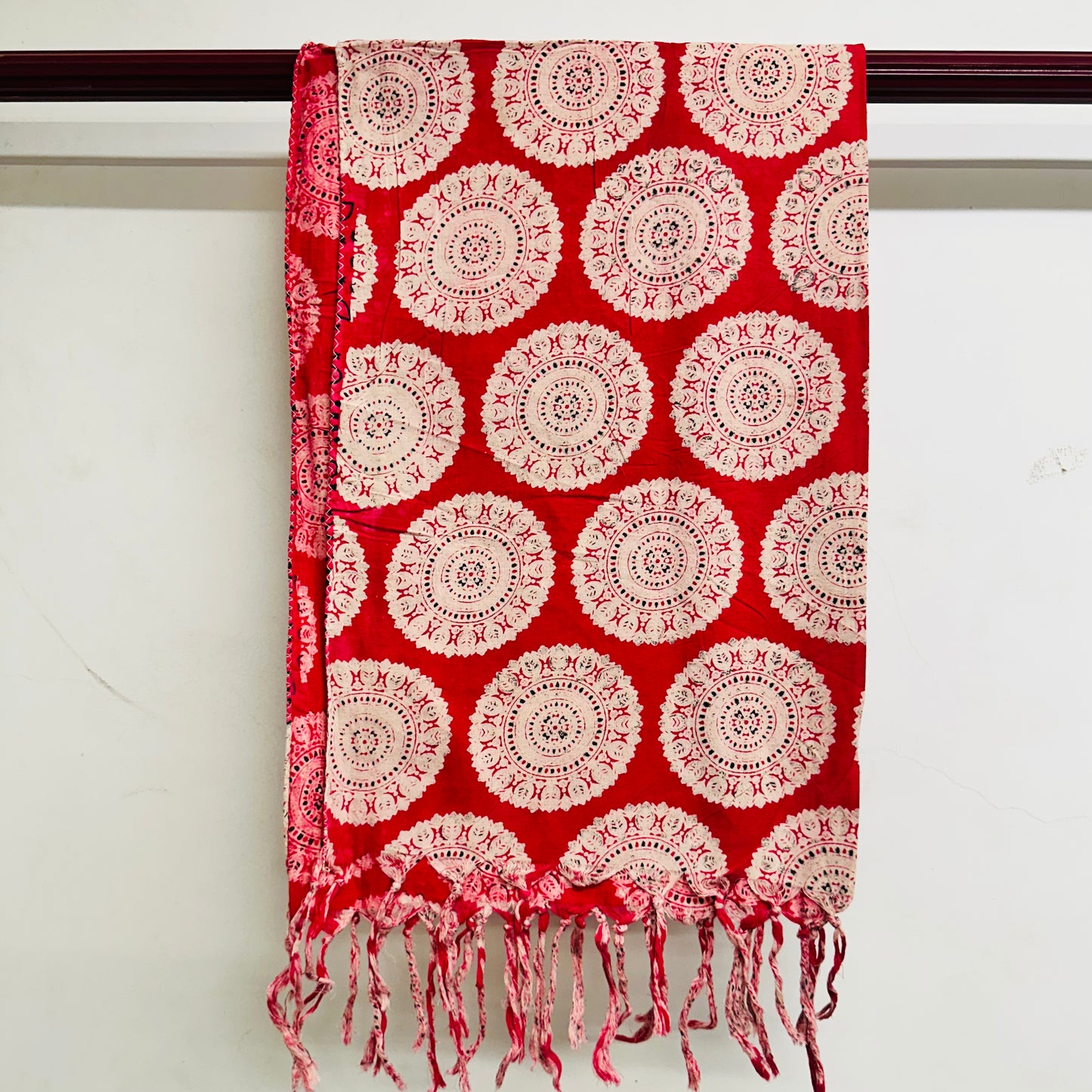 Red scarf with white circular patterns