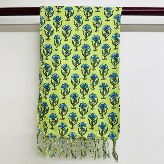 Green scarf with blue floral pattern and tassels